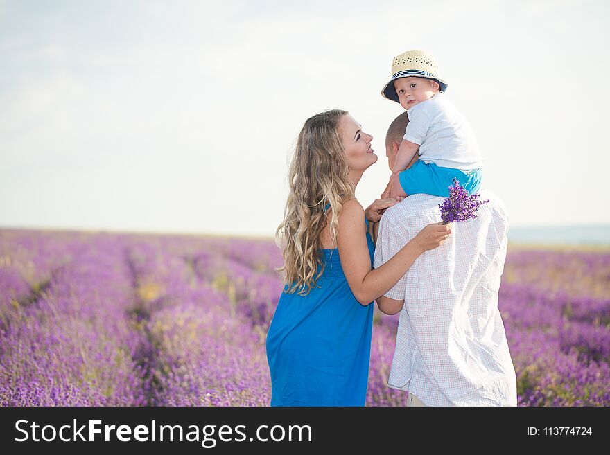 Mom, Dad and their little son are walking in a lavender field. Life in Provence. Mom, Dad and their little son are walking in a lavender field. Life in Provence