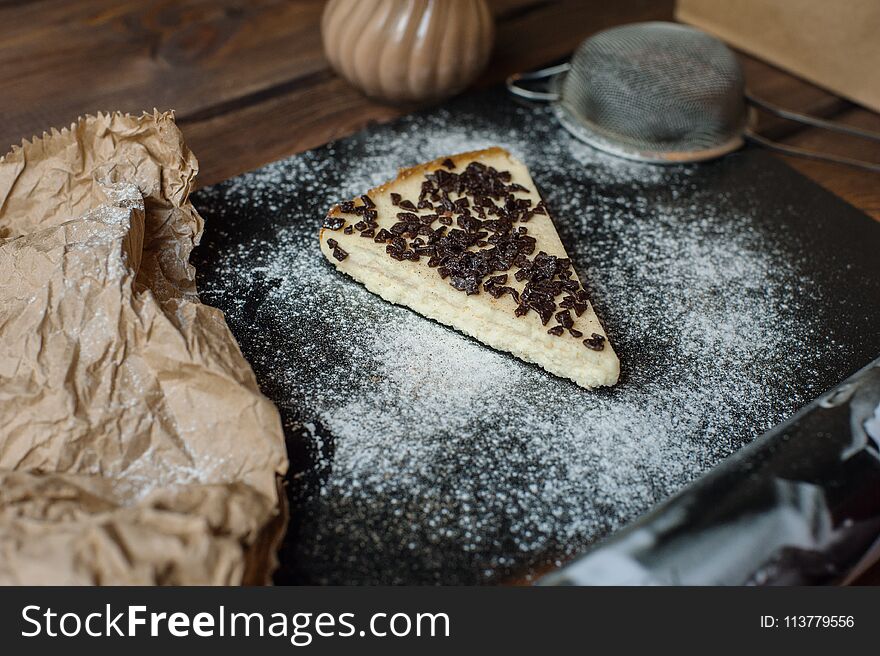 Healthy cake on black background with sugar and cinnamon powder. Healthy cake on black background with sugar and cinnamon powder