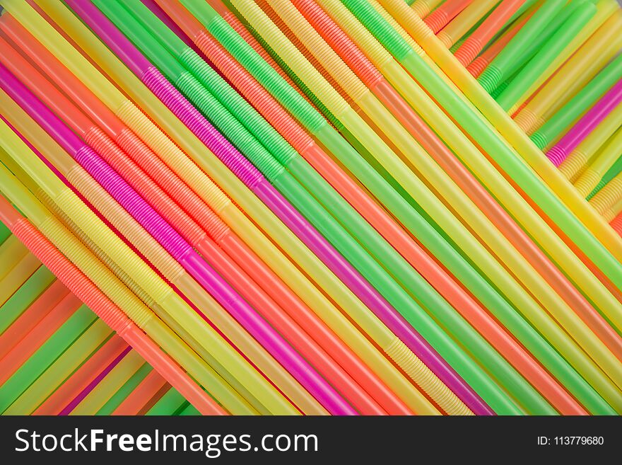 Many colorful straws on table