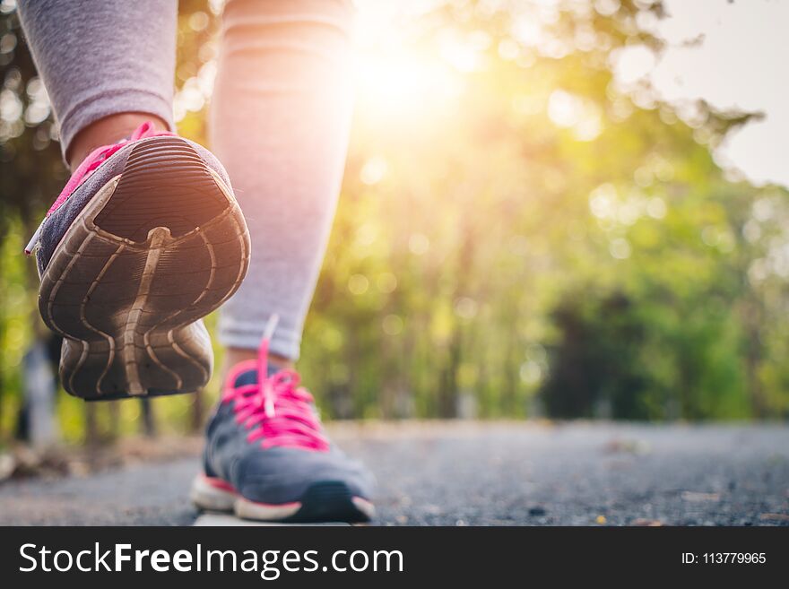 Women runner feet on road in workout wellness.