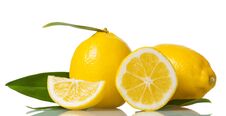 Two Whole Lemons With Leaves And Pieces Isolated On White Stock Image