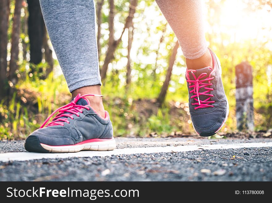 Women runner feet on road in workout wellness.