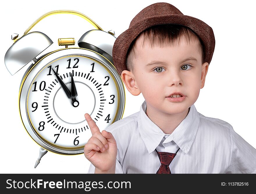 A little boy in a hat is pointing at his watch. The concept of time