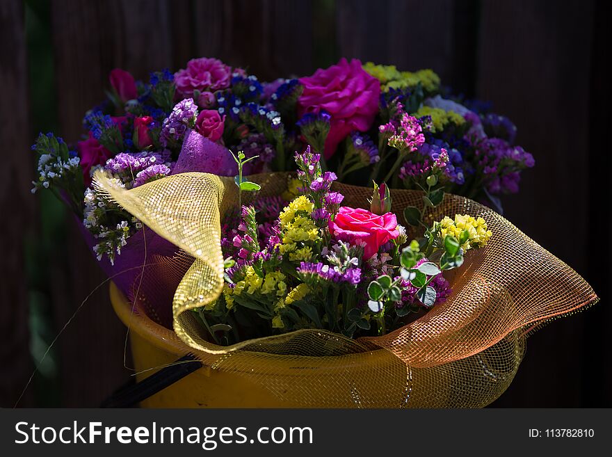 A bouquet of flowers in a bucket
