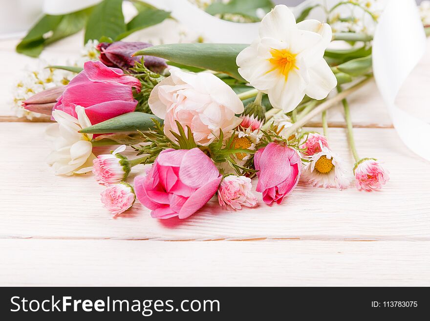 Festive flower pink, white anemones, tulips, daffodils, daisies composition on white wooden desk, background. Overhead top view, flat lay. Copy space. Birthday, Mother`s, Women`s, Wedding Day concept. Festive flower pink, white anemones, tulips, daffodils, daisies composition on white wooden desk, background. Overhead top view, flat lay. Copy space. Birthday, Mother`s, Women`s, Wedding Day concept