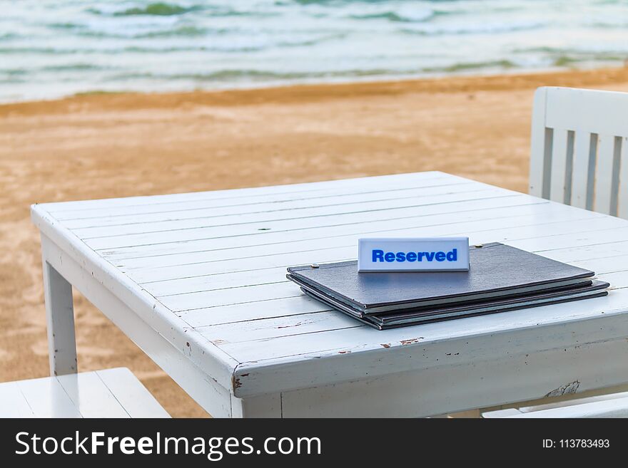 The seaside table with beach and sea background has reserved