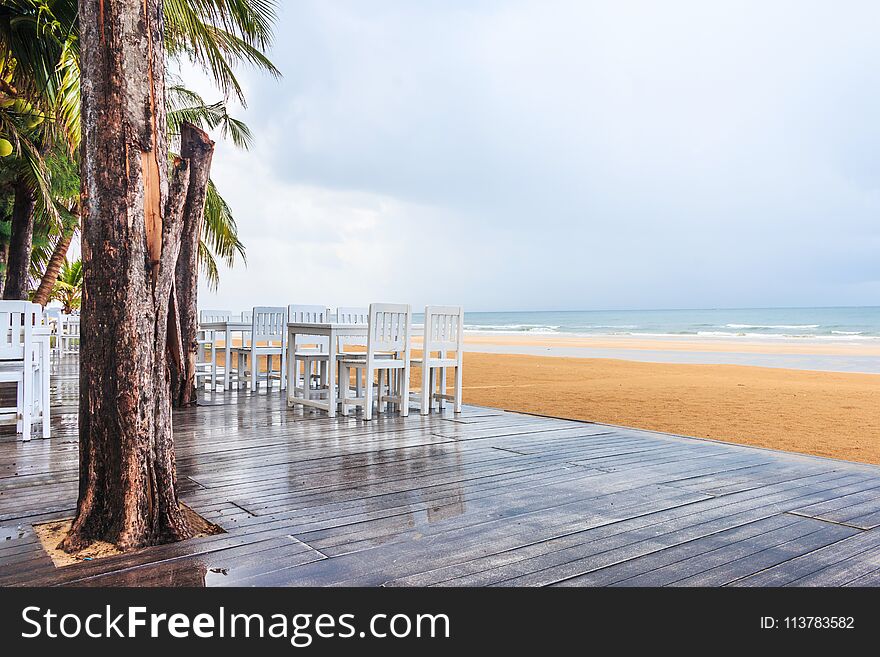 Wood floor and seaside table with beach and sea background after raining