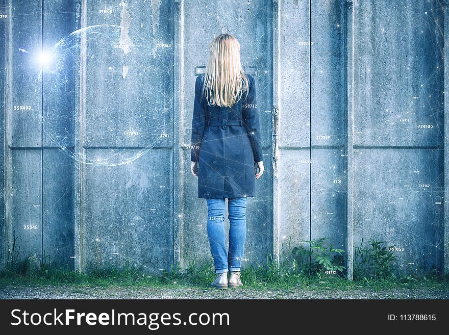 Back view of a business woman stands in front of the concrete wall with digital abstract cyberspace network background. Back view of a business woman stands in front of the concrete wall with digital abstract cyberspace network background.
