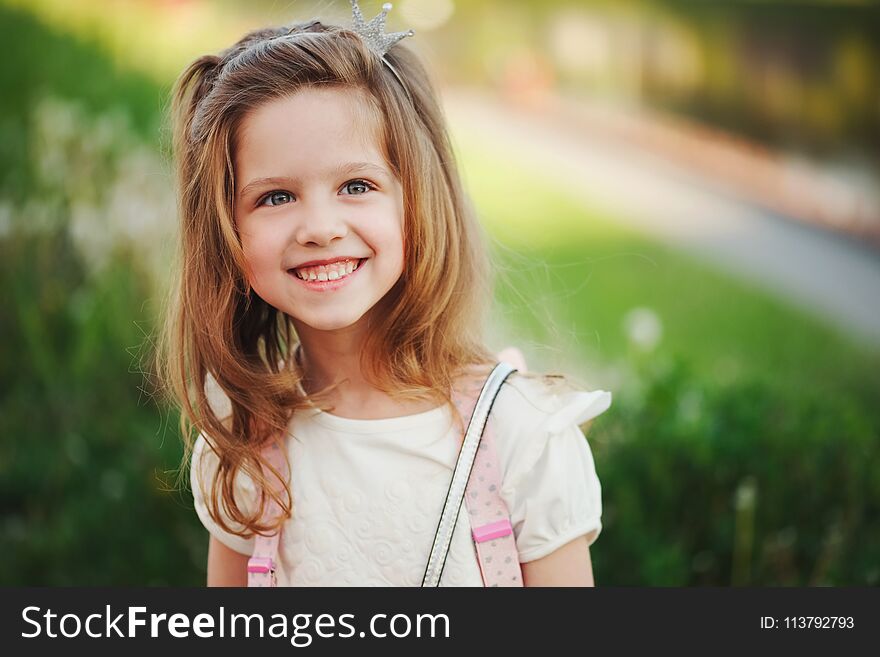 Portrait of cute little girl in summer park