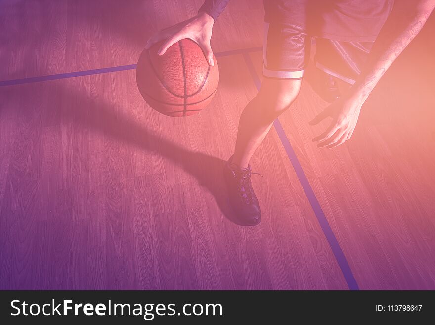 Basketball player in action with basketball court