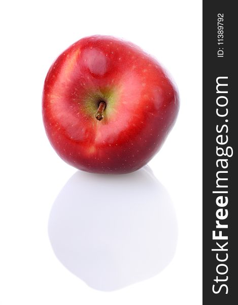 Fresh red apple with stem and reflection on white background