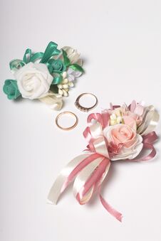 Wedding Decor. Boutonniere Groom With The Bride, Their Wedding Rings, Lie On A White Surface. Royalty Free Stock Photo