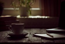 A Cup Of Coffee In The Workplace On A Wooden Table. Royalty Free Stock Photography