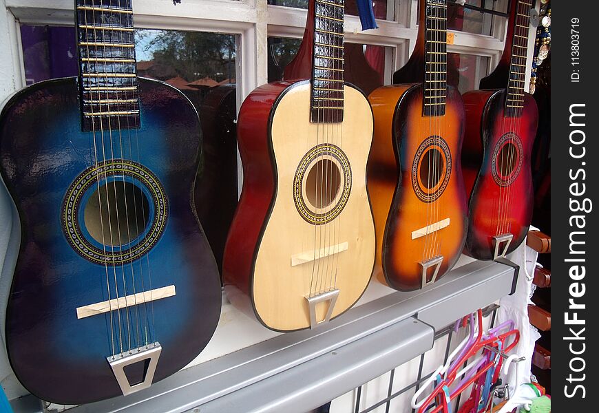 A line of guitars on a wall