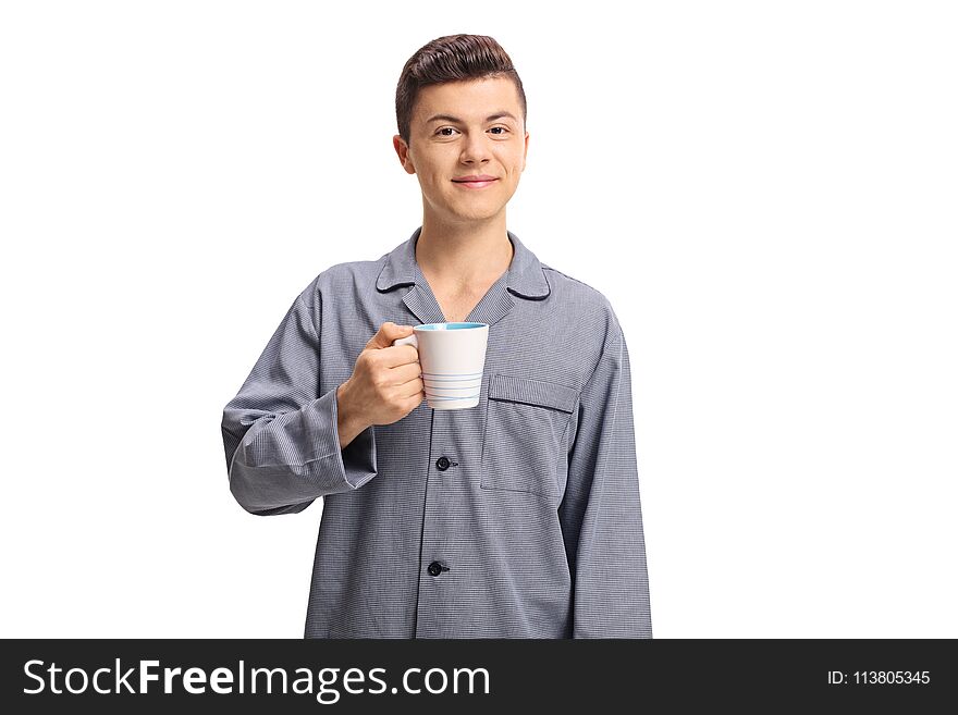 Teenage boy wearing pajamas and holding a cup isolated on white background