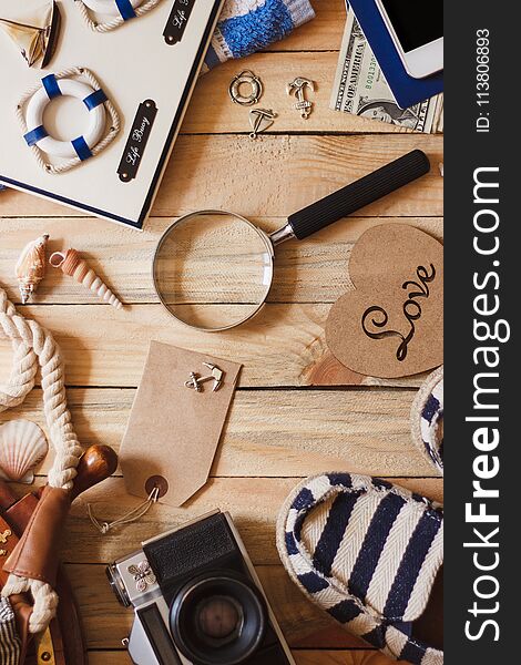 Striped Slippers, Camera, Phone And Maritime Decorations On The Wooden Background