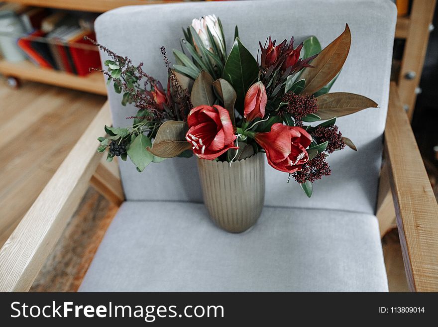 Red Tulip Flowers in Vase on Armchair