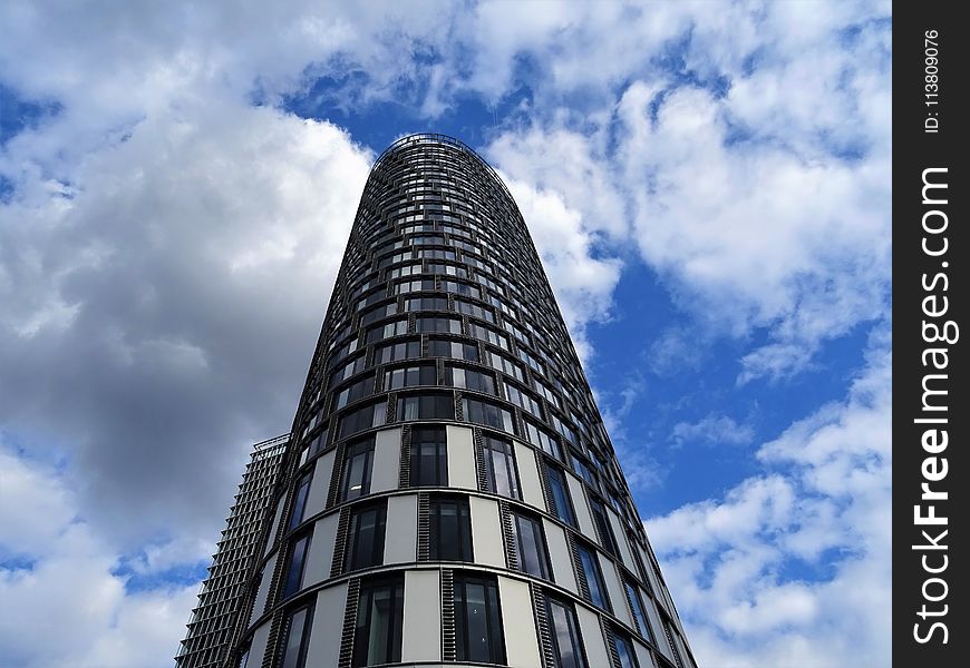 Gray Concrete Building During White Cloudy Skies