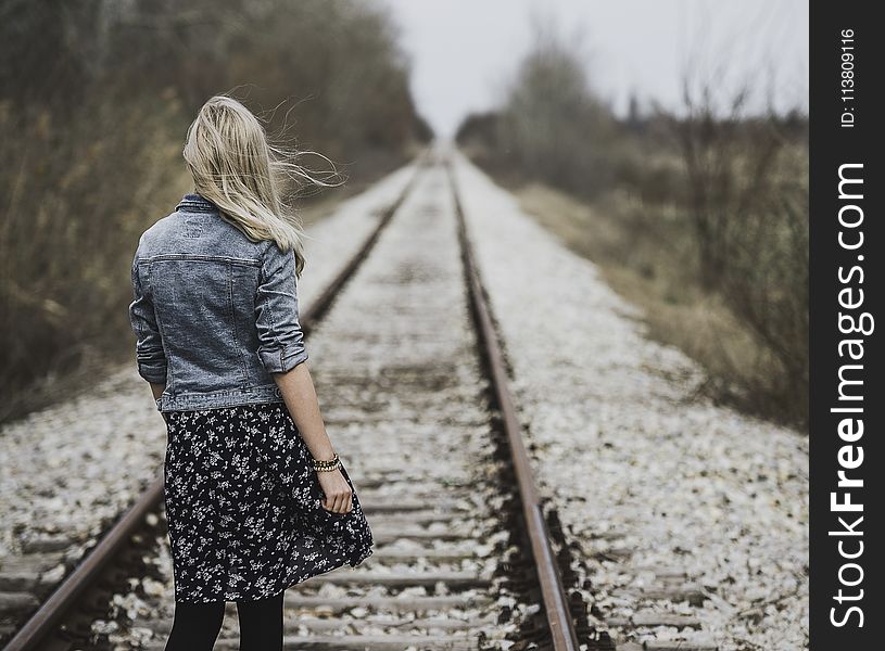 Woman Standing on Railroad
