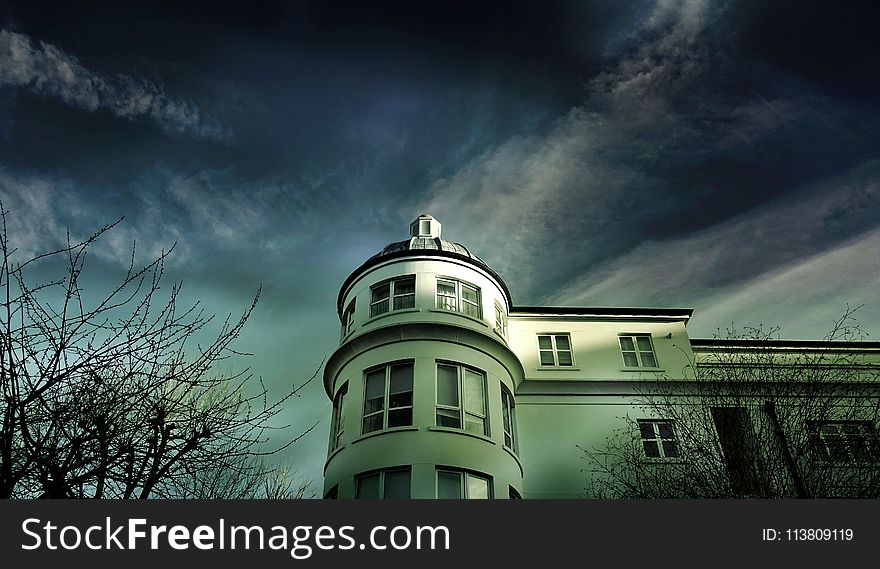White Painted House Under Cloudy Sky