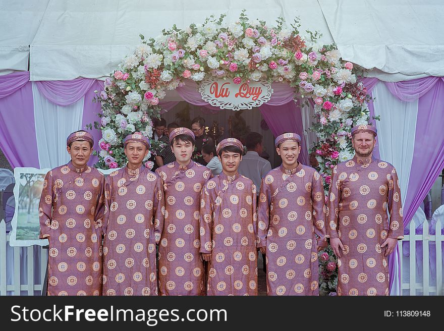 Group of Men Wearing Pink Robes