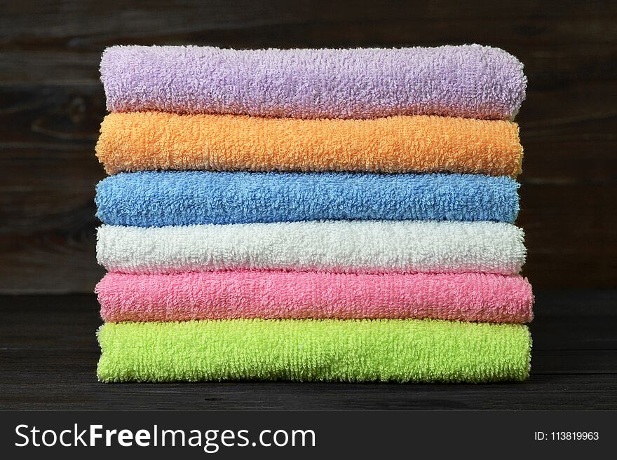 Bath towels on wooden background