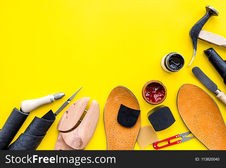Clobber Tools. Hummer, Awl, Knife, Sciccors, Wooden Shoe, Paint And Leather. Yellow Background Top View Space For Text