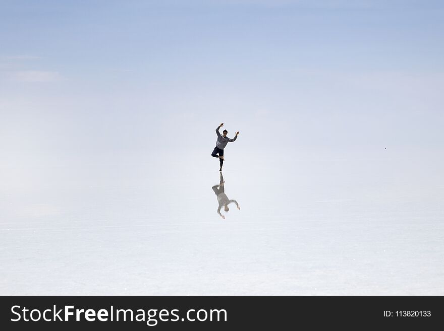 Young man in at Salar de uyuni salt flat in Bolivia