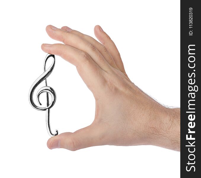 Hand holding a treble clef