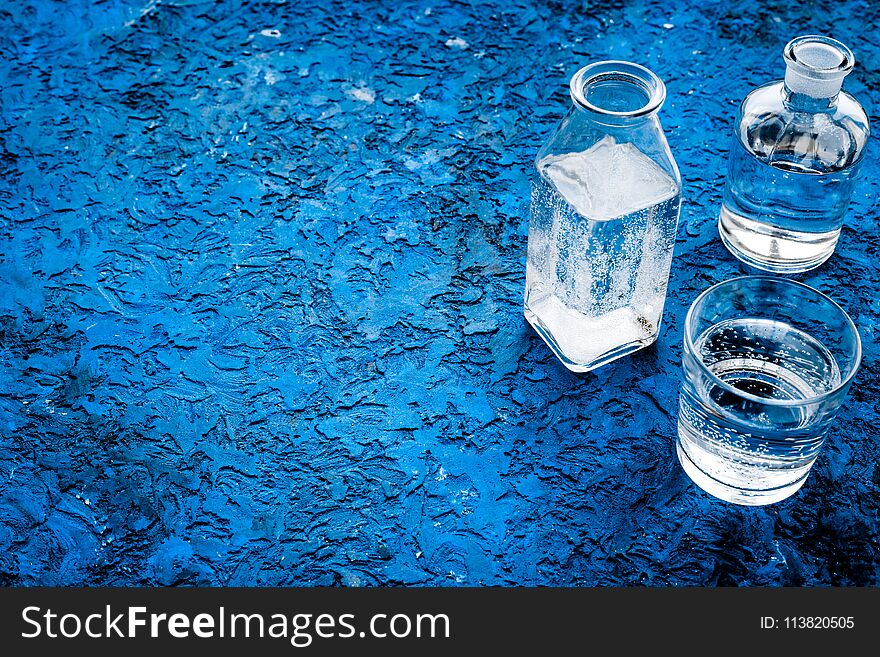 Drinks on the table. Pure water in jar and glasses on blue background space for text