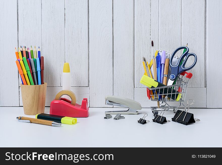 Education, Back to School, Shopping with shopping cart on table with White wooden vintage wall