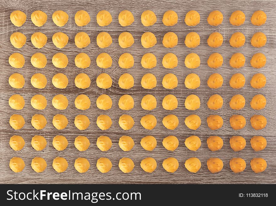 Rows of colorful tasty sweets pattern on wooden background. Rows of colorful tasty sweets pattern on wooden background