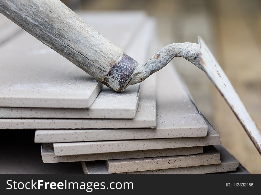 Laying and cutting tiles. Tools and building materials at a working position. Tiles for industrial and technical applications. Material Gres.