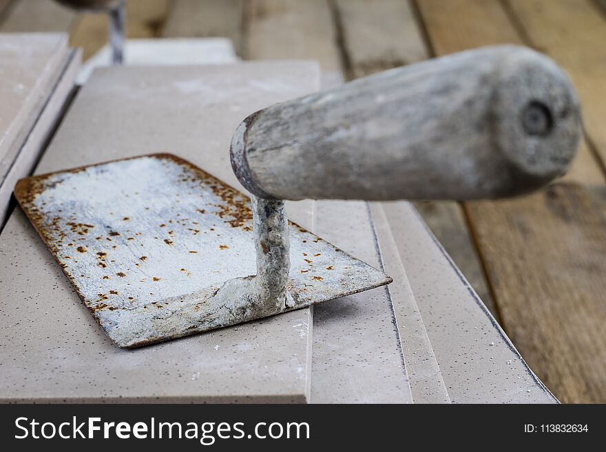 Laying and cutting tiles. Tools and building materials at a work