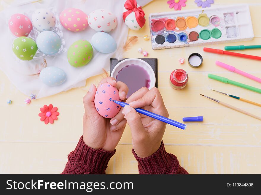 Happy easter! A woman hand holding for painting Easter eggs