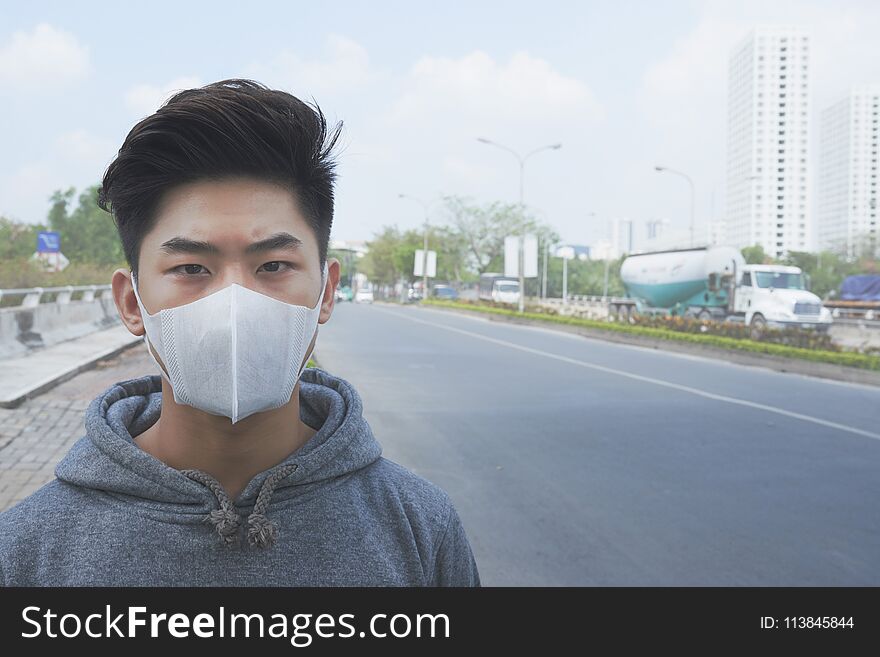 Young Asian man living in city with polluted air. Young Asian man living in city with polluted air