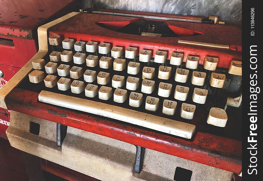 Old red and white typewriter.Vintage type word. Back to the basic.