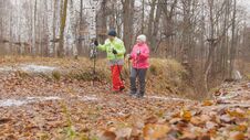 Fitness For Elderly Women In Autumn Park - Nordic Walking Among Autumn Park Stock Photos