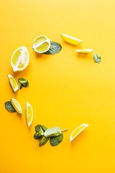 Bright Mint Leaves And Lemon Slices On Yellow Stock Photography