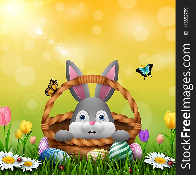 Illustration of Cute Easter bunny in a basket with colorful eggs on the grass