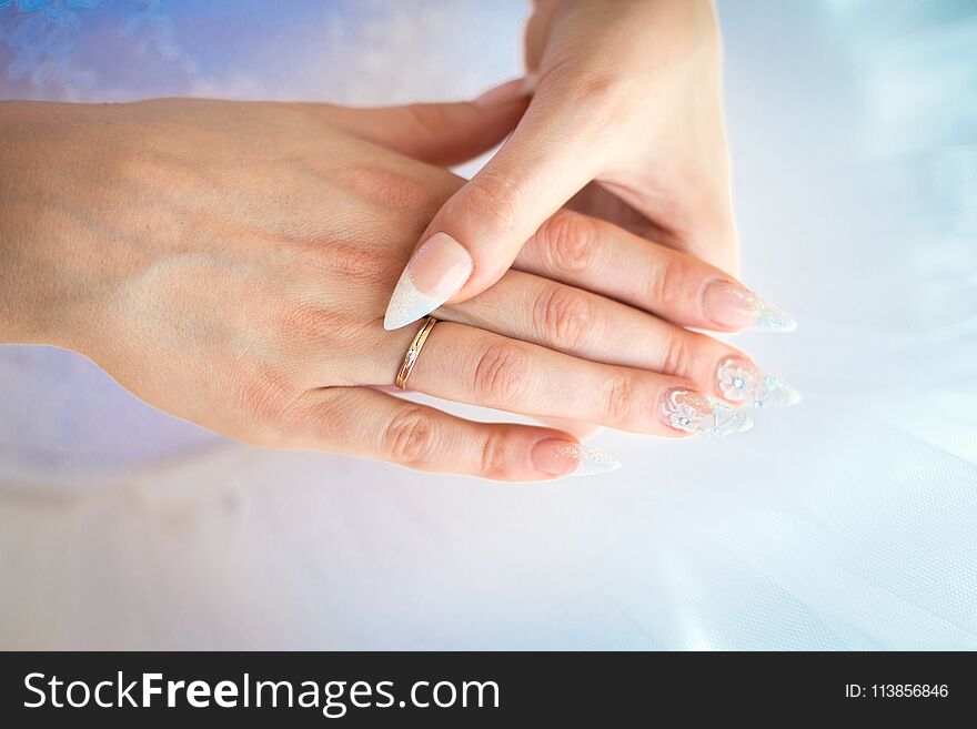 Bride hands with wedding ring on fingers and beautiful nails