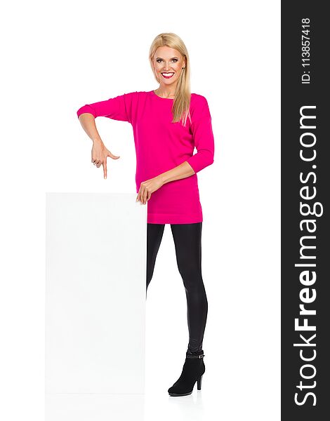 Beautiful Blond Woman Is Smiling And Pointing At Blank White Board