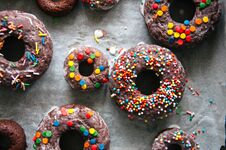 Baked Chocolate Doughnuts With Glaze And Confectionary Topping O Stock Images