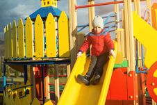 Happy Little Boy Have Fun And Sliding On Colorful Modern Playground In Park. Royalty Free Stock Photography