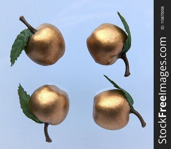 Golden apples isolated on gray background as a festive or christmas pattern. Golden apples isolated on gray background as a festive or christmas pattern