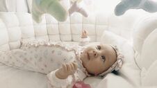 Adorable Newborn Baby Girl In Her Cot Stock Photos