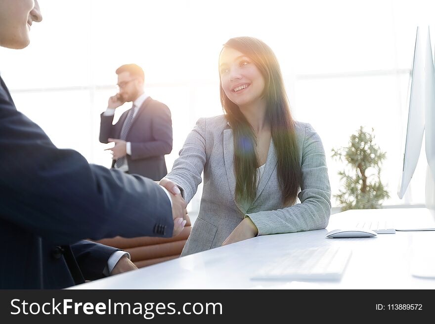 Business woman shaking hands with a business partner.