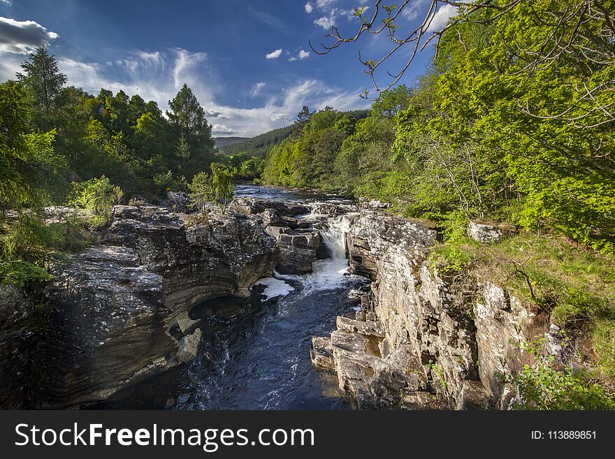 Beautiful river landscape in the Scottish highlands The water flow down the waterfall. Beautiful river landscape in the Scottish highlands The water flow down the waterfall.