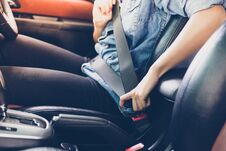 Asian Woman Fastening Seat Belt In The Car, Safety Concept Royalty Free Stock Image