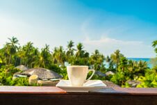 White Coffee Cup With Beautiful Paradise Island Sea And Beach Royalty Free Stock Photos